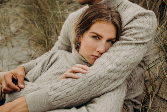 a couple wearing lichen cable sweaters