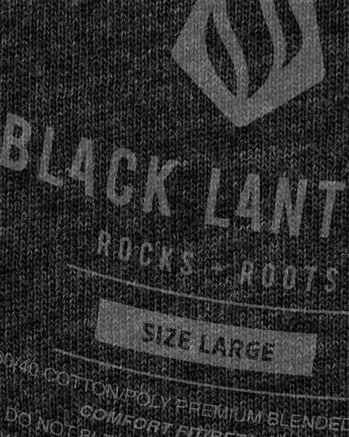 Close up of the printed design on dark fabric showing distressed cactus silhouettes and a sun with Saguaro National Park text.