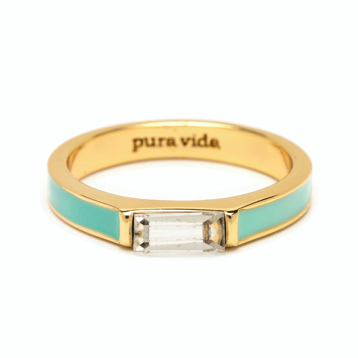 Close-up of turquoise enamel two-tone ring with a rectangular gemstone and pura vida inscription on the inner band.