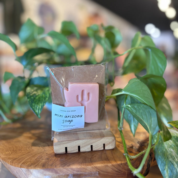 Pink mini Arizona soap bar with cactus imprint in plastic wrap on brown cardboard packaging.