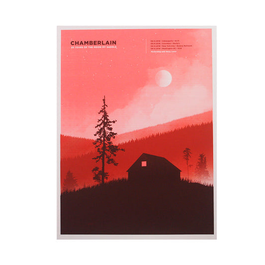 A striking 18 x 24 poster from Chamberlain features a red gradient background with a cabin and trees silhouetted on a hillside under a large moon. “CHAMBERLAIN: 20 Years of The Moon My Saddle” headlines the concert details in white.