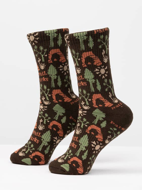 National Park Roundup socks in brown and green with forest motifs such as trees and plants