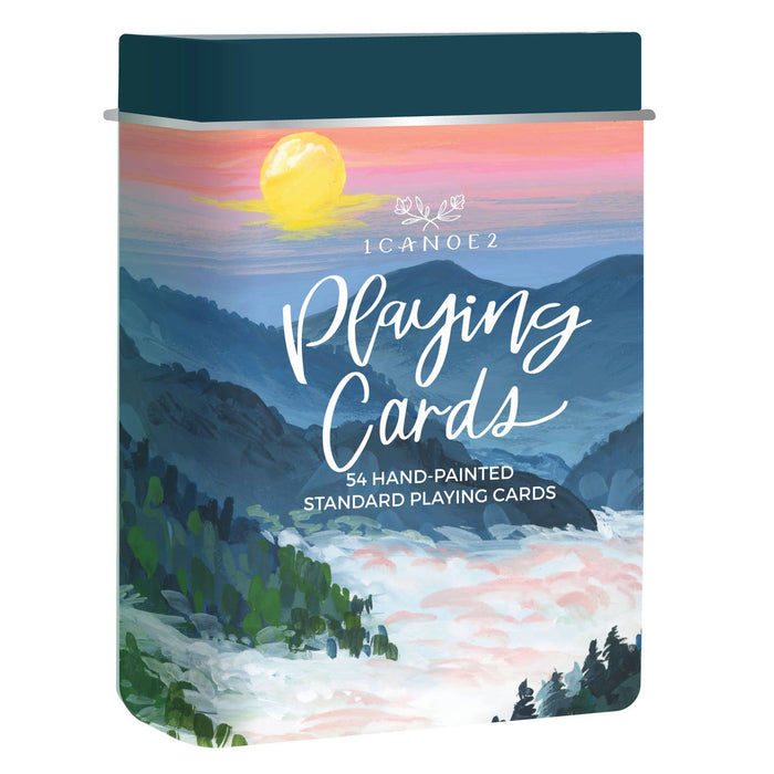 Colorful illustrated National Parks Playing Cards Travel Tin cover featuring mountains at sunset.
