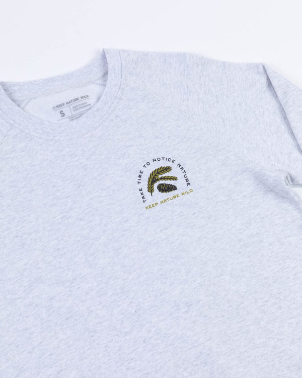 Front view of ash sweatshirt with circular Keep Nature Wild logo on the left chest.