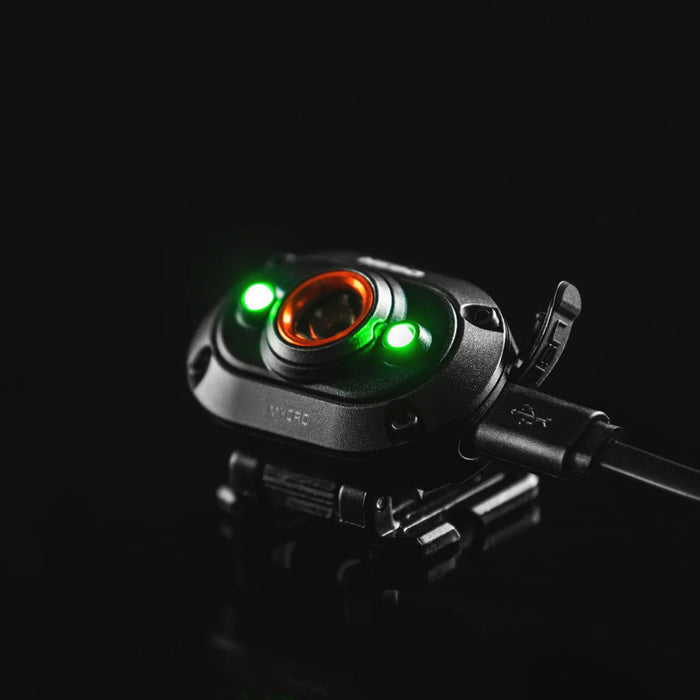 Studio shot on a black background of NEBO Mycro rechargeable 400 lumens LED head torch being charged