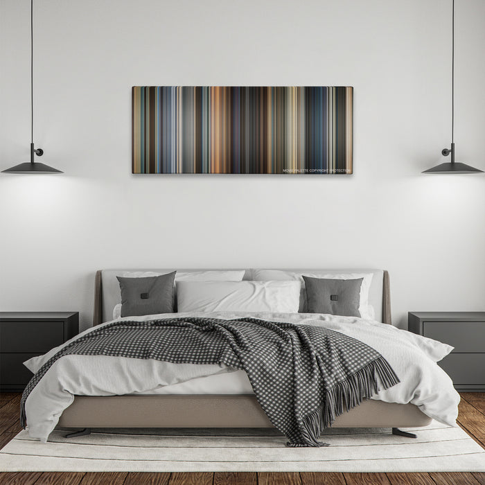 Now You See Me color palette canvas above a bed, between two black pendant lamps