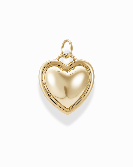 The Olivia Puffy Heart Charm is a shiny, nickel-free 14k gold heart-shaped pendant with a smooth surface and a top loop for attaching to a chain, shown against a white background.