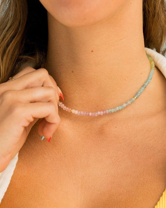 Ombre pastel bead choker in pink to blue tones around a model's neck