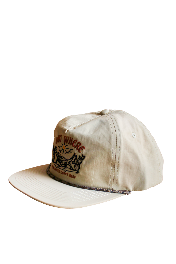 Back view of a beige cap showing an adjustable strap and CW label.