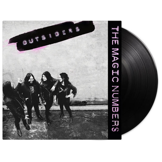 A black vinyl record partially in its cover. The cover shows four people in black outfits against a wall. “OUTSIDERS” is written in purple at the top, with “The Magic Numbers” and Rebel Song also in purple on the right. Brand: The Magic Numbers.