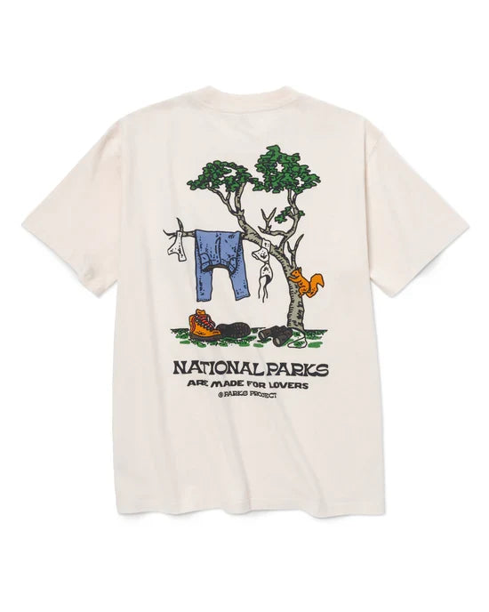 Back of cream Park Lovers Tee with a camping scene featuring trees, a clothesline with garments, and National Parks are made for lovers.