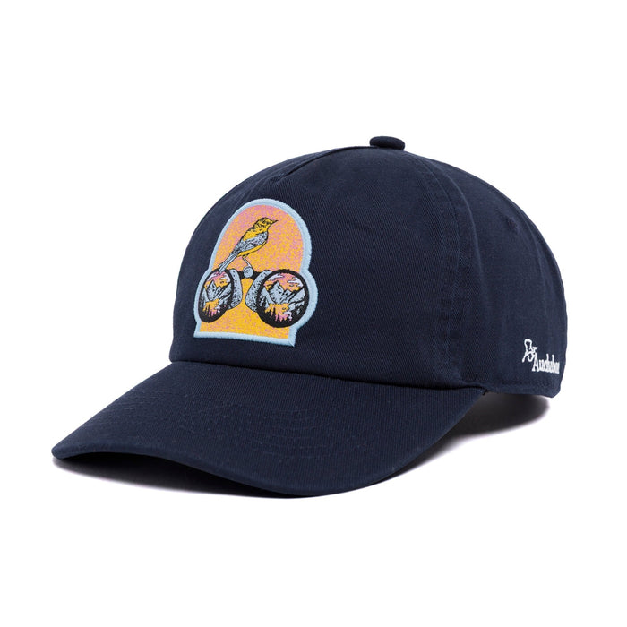 Three quarter view of the navy Parks Project x Audubon hat with the colorful patch on the front panel.