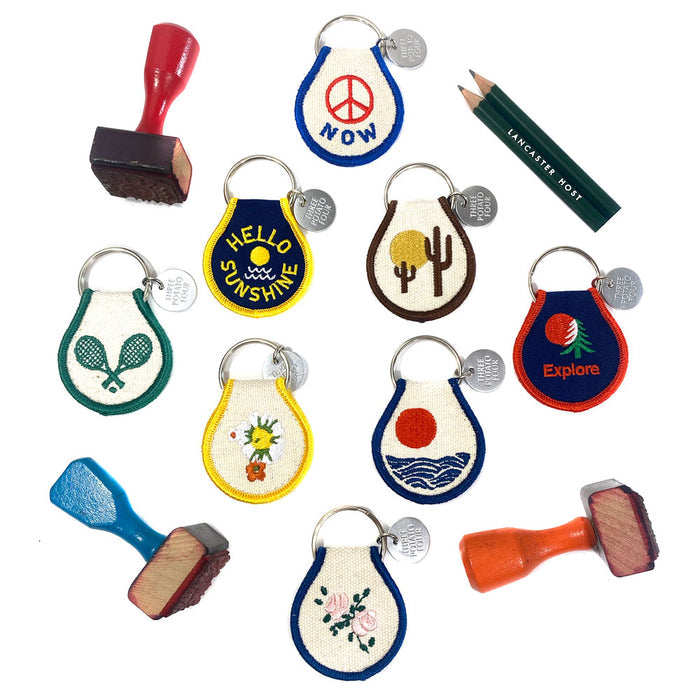 Assorted Desert Vibes patch keychains in bright colors and various desert designs for display.