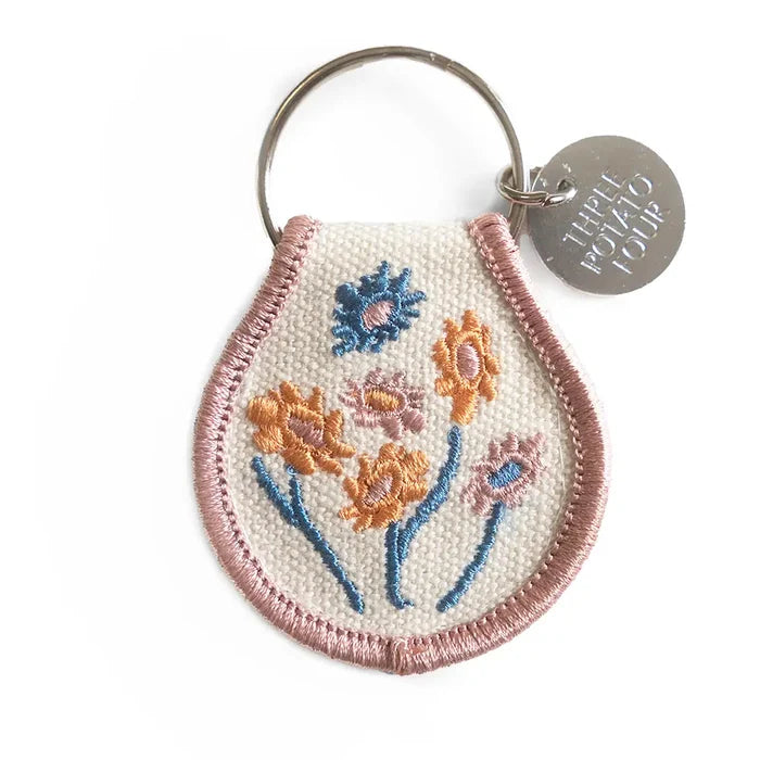 Pastel floral embroidered patch keychain in teardrop shape with pink edging