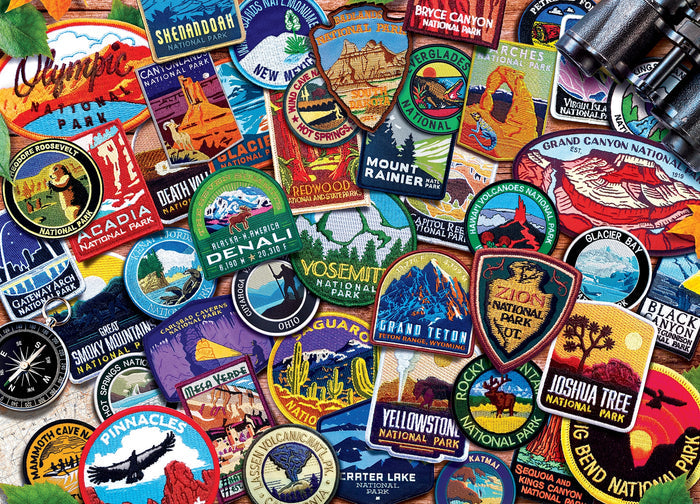 Colorful assortment of National Parks patches spread on a wooden surface, each patch showing a different park.