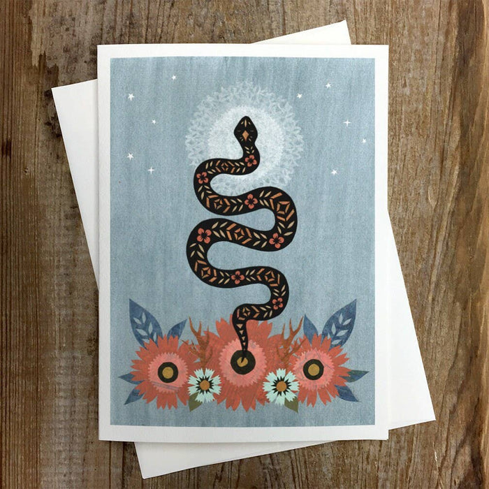 Peaceful Departure greeting card with a stylized coiled snake and floral wreath on a pale blue background
