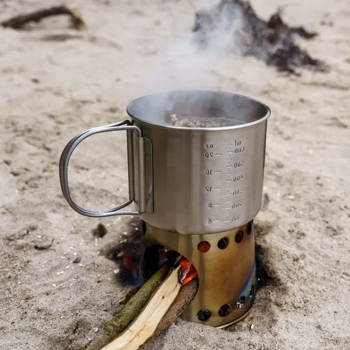 Petromax stove cup being used outdoors on the beach using driftwood to cook