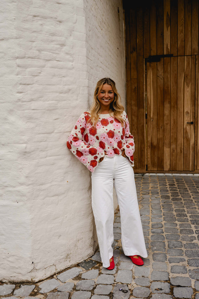 Pink red crochet blouse styled with white jeans