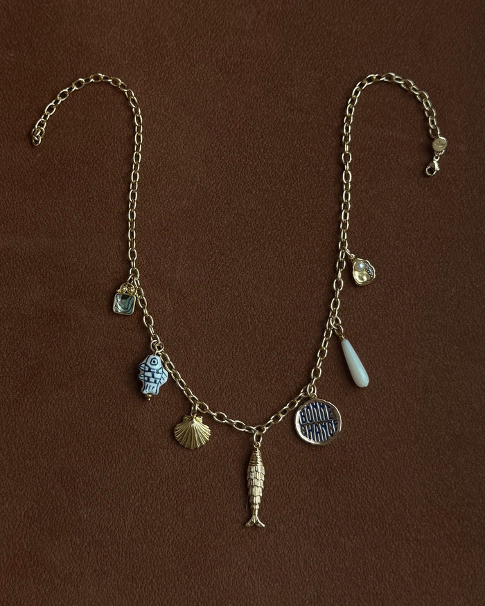 Necklace with various charms on a brown background