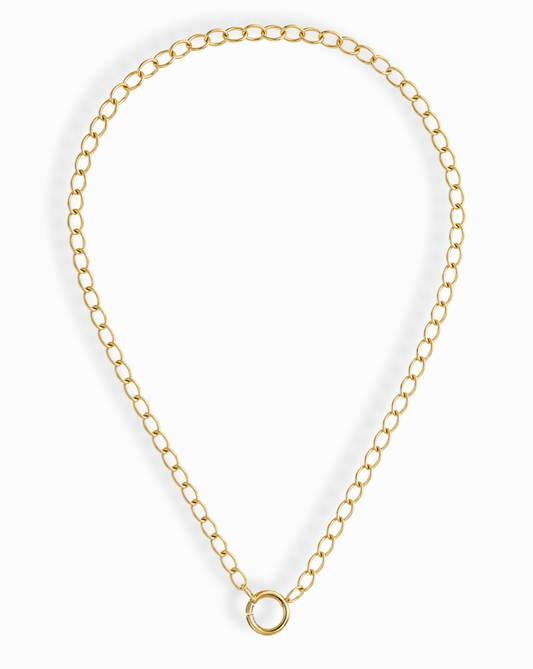 The Presley Charm Clip Necklace by Mod + Jo features 14k gold plating, evenly spaced oval links, and a central circular clasp—ideal as a base chain for charms. Shown against a white background.