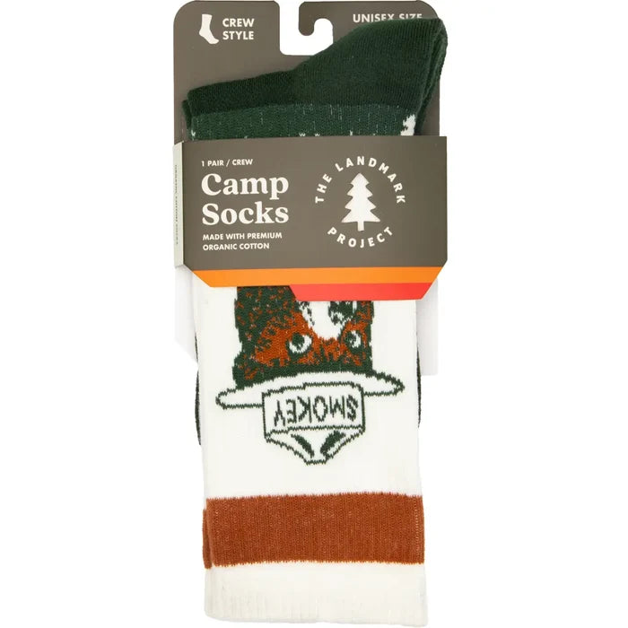 Camp Socks packaging displaying a forest themed design with a dark green cuff.