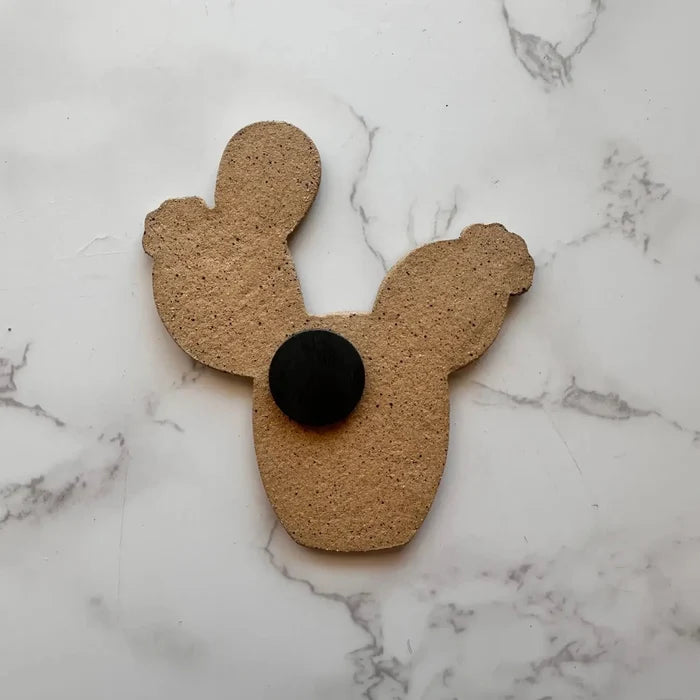 Back of prickly pear cactus ceramic magnet showing cork backing and black round magnet.