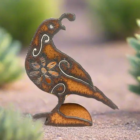 Rusty metal quail cutout standee with floral cutouts perched on a curved base for garden decor.