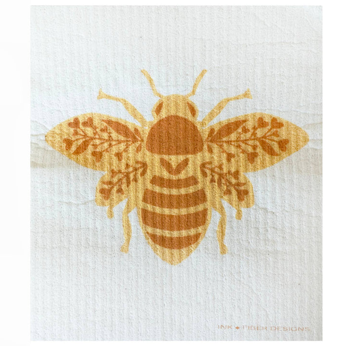 Queen Bee Swedish Dishcloth with a golden bee graphic on textured white fabric.