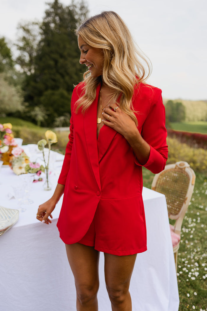 Model wearing red Luzy blazer romper