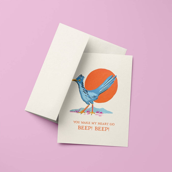 Roadrunner Love Card on a pink background with stacked beige cards behind