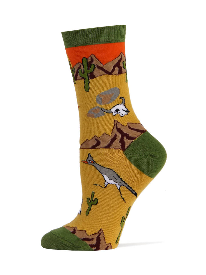Roadrunner women's sock with desert motif featuring mountains, cacti, and a roadrunner on a yellow background