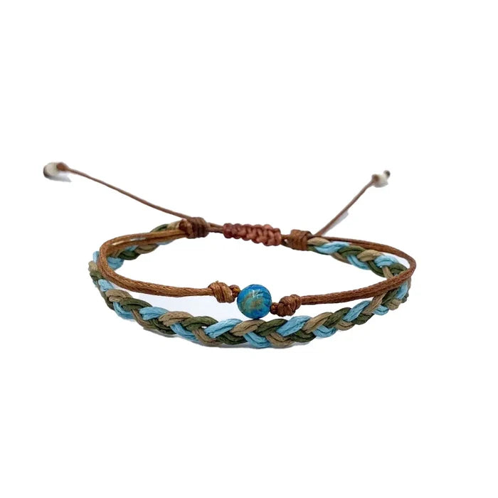 Bracelet with brown leather cord and braided turquoise and olive strands featuring a blue central bead