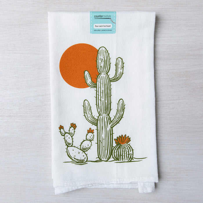 White tea towel with a green cactus and an orange sun design.