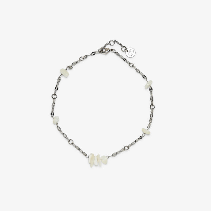 Sea Treasures Anklet close-up with a silver chain and small white shell beads and a round charm