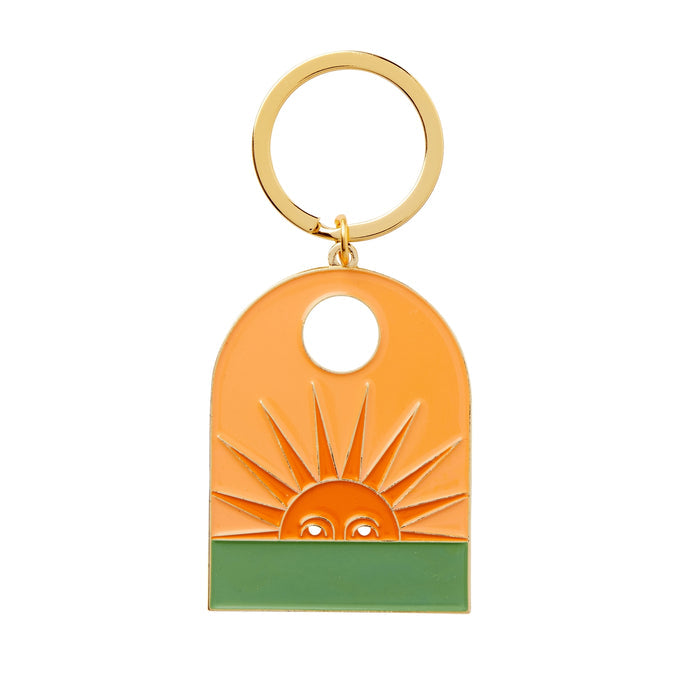 Setting Sun enamel keychain with an orange sun and green base and a gold ring