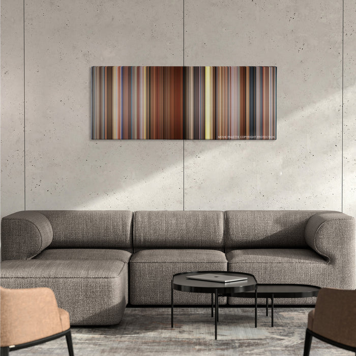 Sideways color palette canvas on a concrete wall above a gray sectional sofa