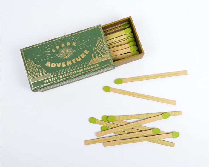 Box with lid removed showing Spark Adventure faux matches and lime green tips with printed text on the sticks
