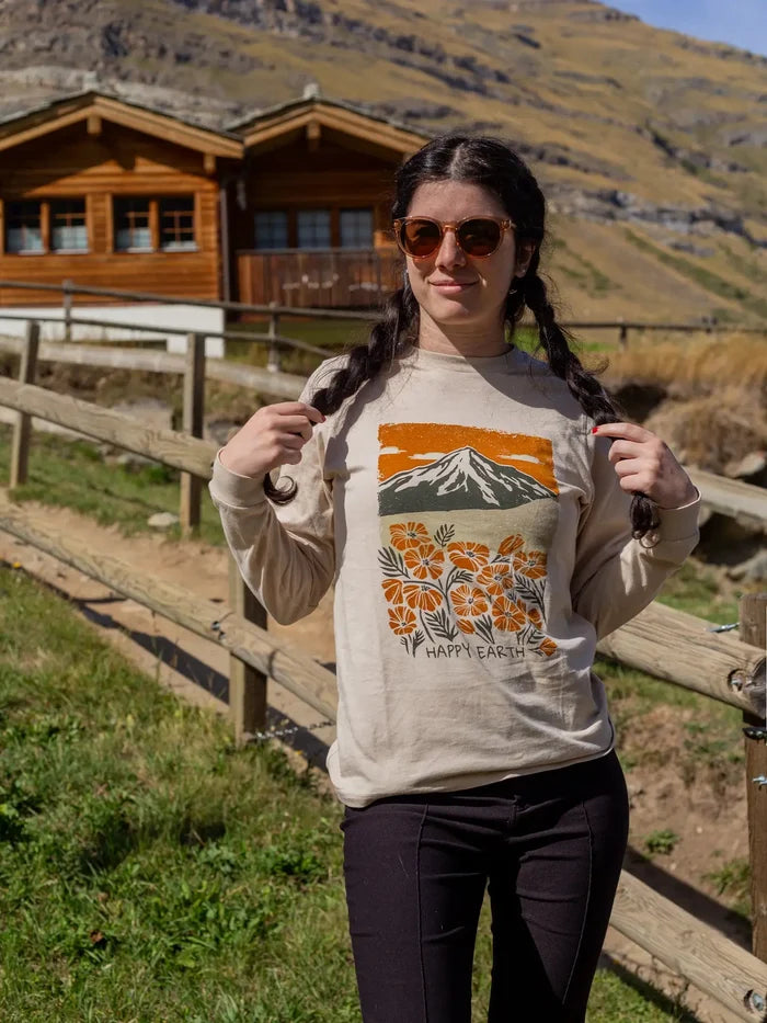 Woman wearing Spring Fever long sleeve beige shirt with mountain and floral print outdoors