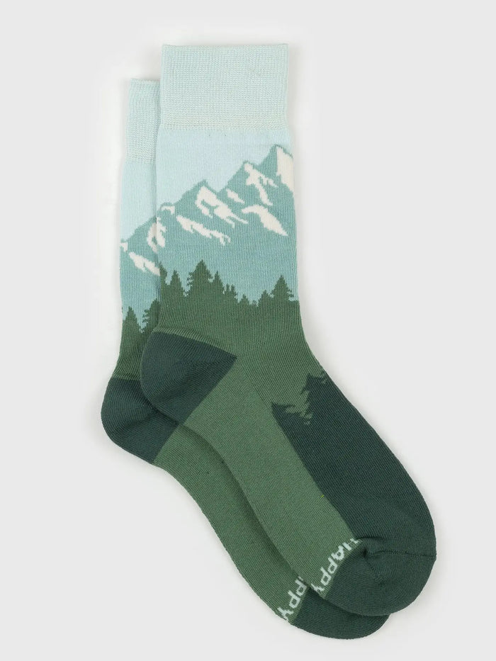 Light turquoise Tetons Socks with a mountain pattern and a twine attached tag.