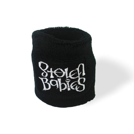 A black wristband from Stolen Babies features “Stolen Babies” embroidered in white, stylized lettering. It is shown on a plain white background with a faint shadow underneath.