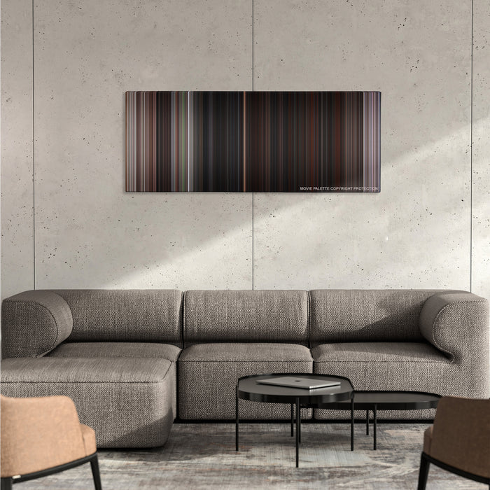 The Goonies color palette canvas on a concrete wall above a gray sectional sofa