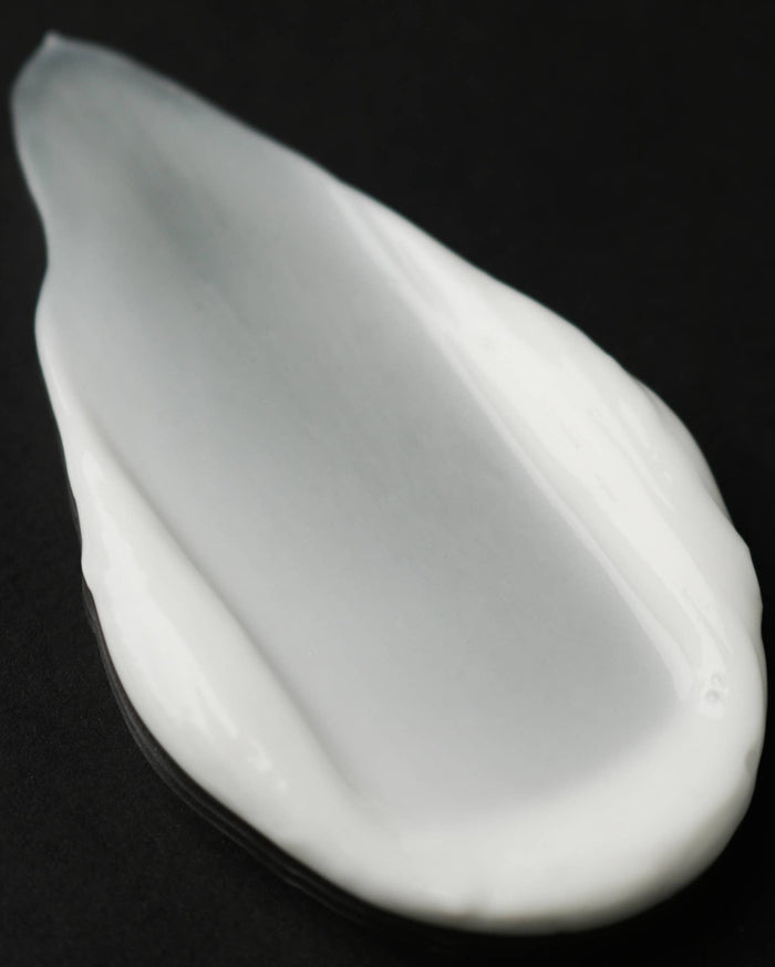 White ceramic teardrop-shaped object on a black background