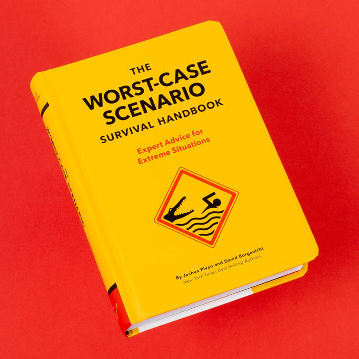 Open page from The Worst-Case Scenario Survival Handbook showing How to Land a Plane heading on a white panel against a red background