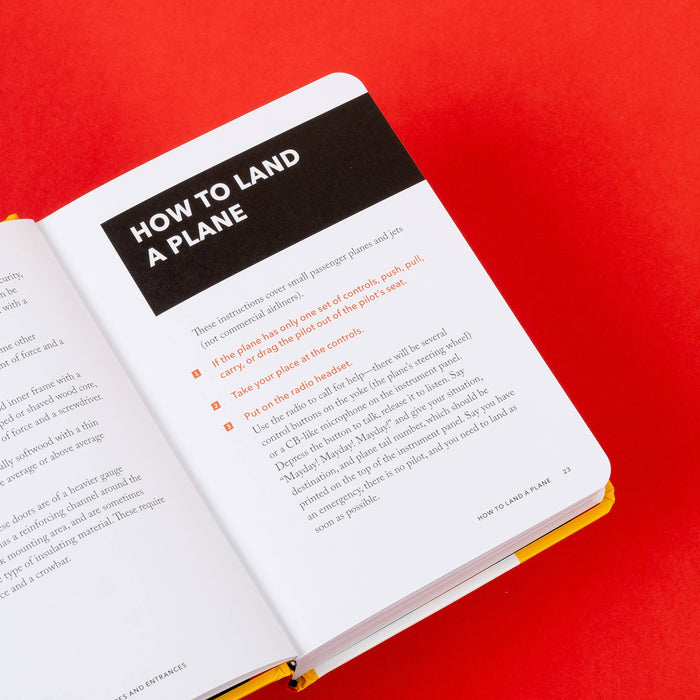Angled view of the yellow book resting on a red surface with visible page edges and rounded corner