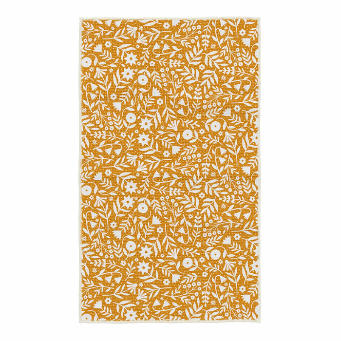 Meadow Flowers kitchen towel with white pattern on mustard yellow background laid flat.