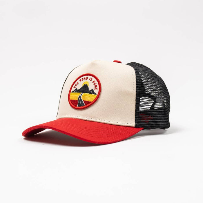 Road Trucker Hat with beige front panel red brim and black mesh back featuring a round patch with a road through mountains.
