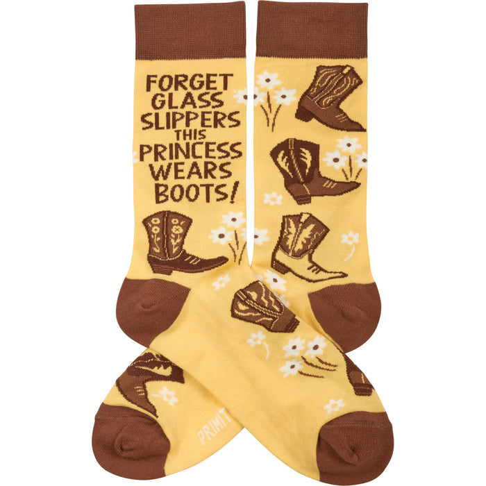 Yellow socks with brown toe and cuff featuring boots, flowers, and the line Forget Glass Slippers This Princess Wears Boots