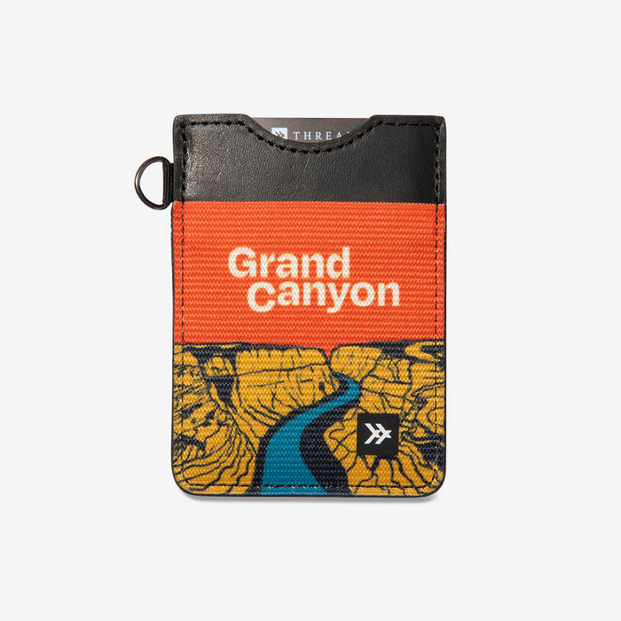 National Parks themed vertical wallet featuring Grand Canyon scene in orange and yellow with blue river and brown leather top