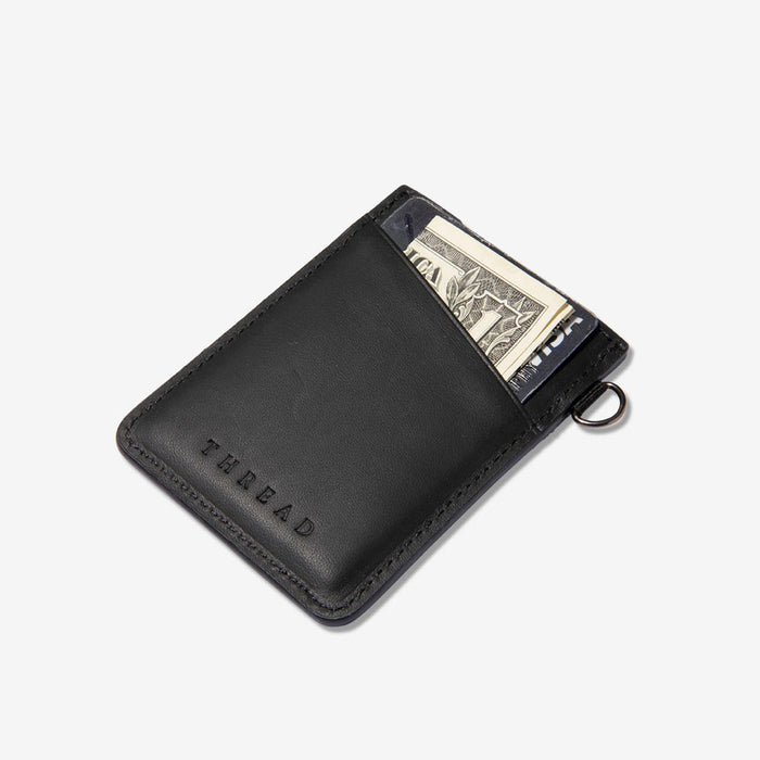 Black vertical leather wallet from National Parks collection with card slots and a metal key ring.