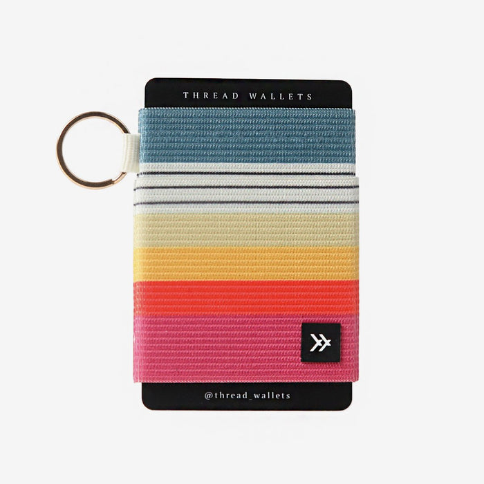 Rainbow striped elastic wallet with a gold key ring.